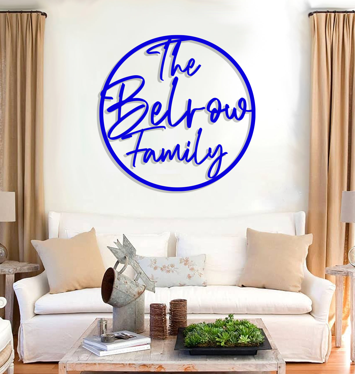 a living room with a white couch and a blue sign on the wall