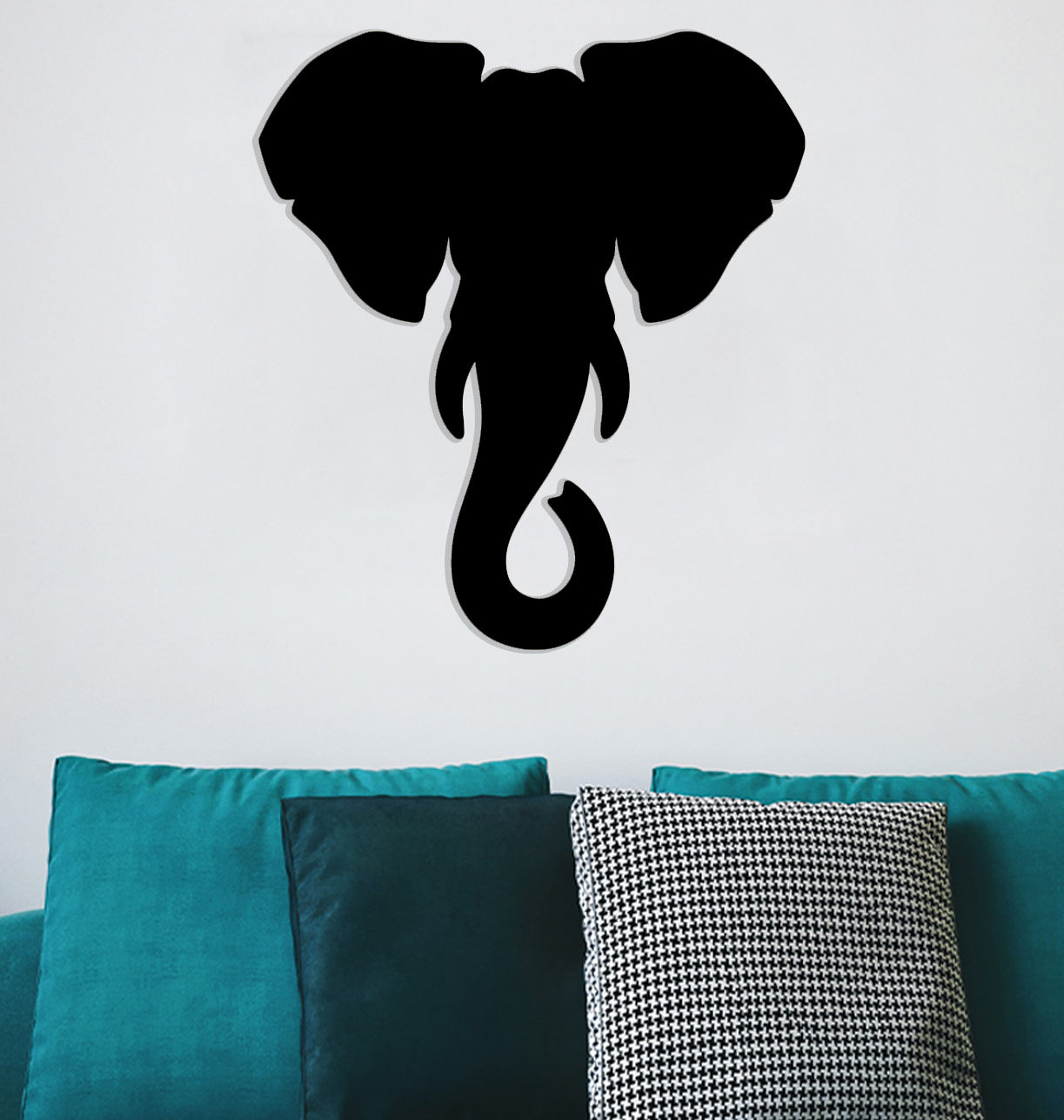 a black elephant head on a white wall
