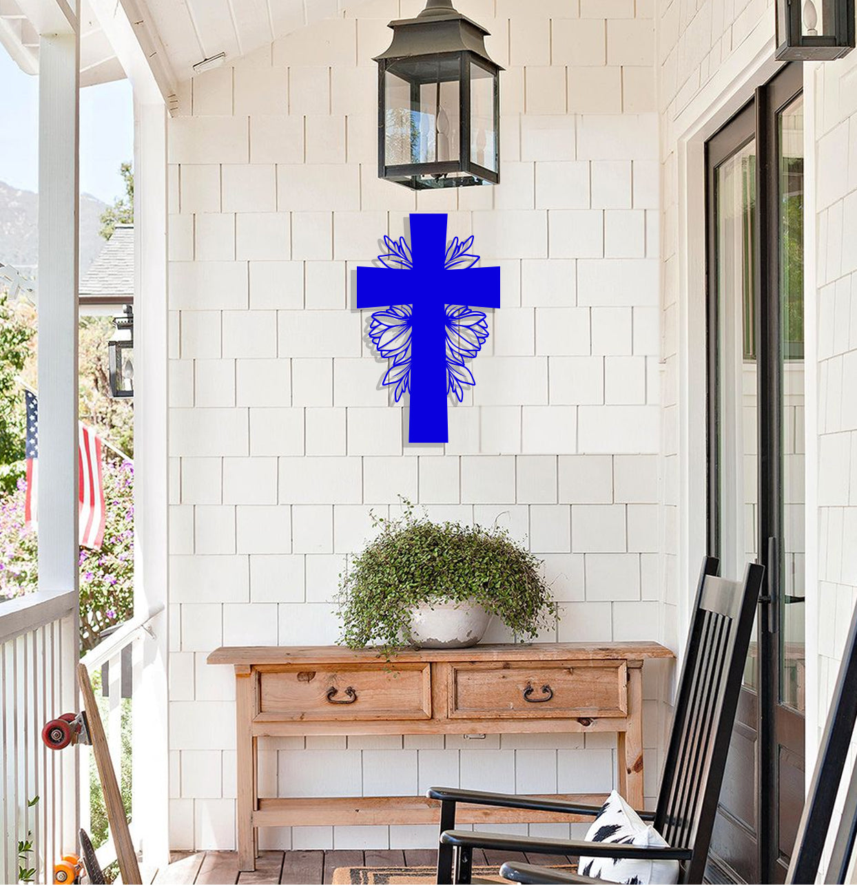 a blue cross hanging on the side of a house