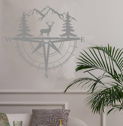 a living room with a plant and a compass wall decal