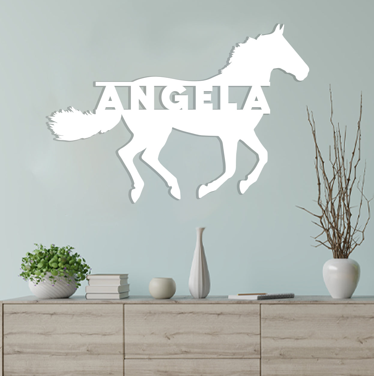 a white horse decal on a wall above a dresser