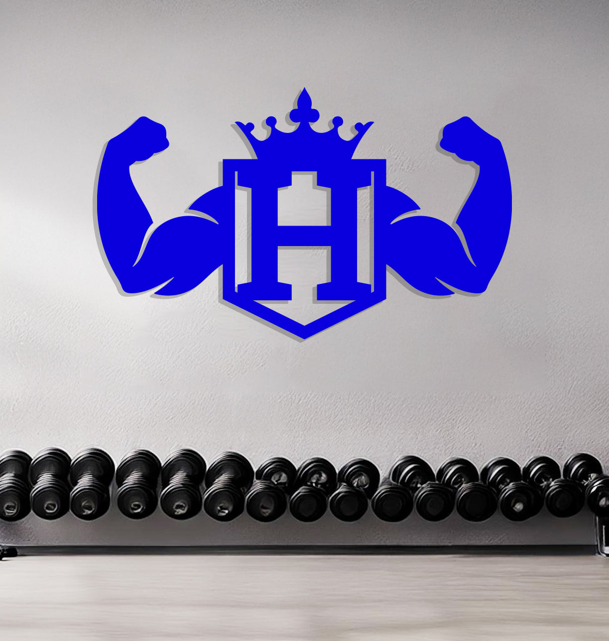 a wall with a gym logo and a row of kettles