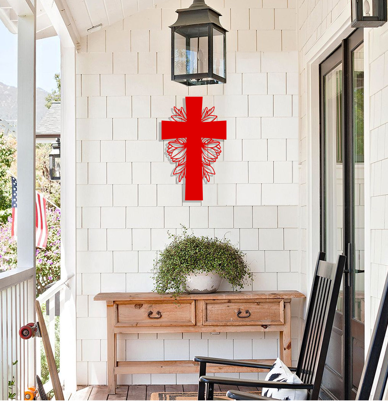 a red cross hanging on the wall of a porch