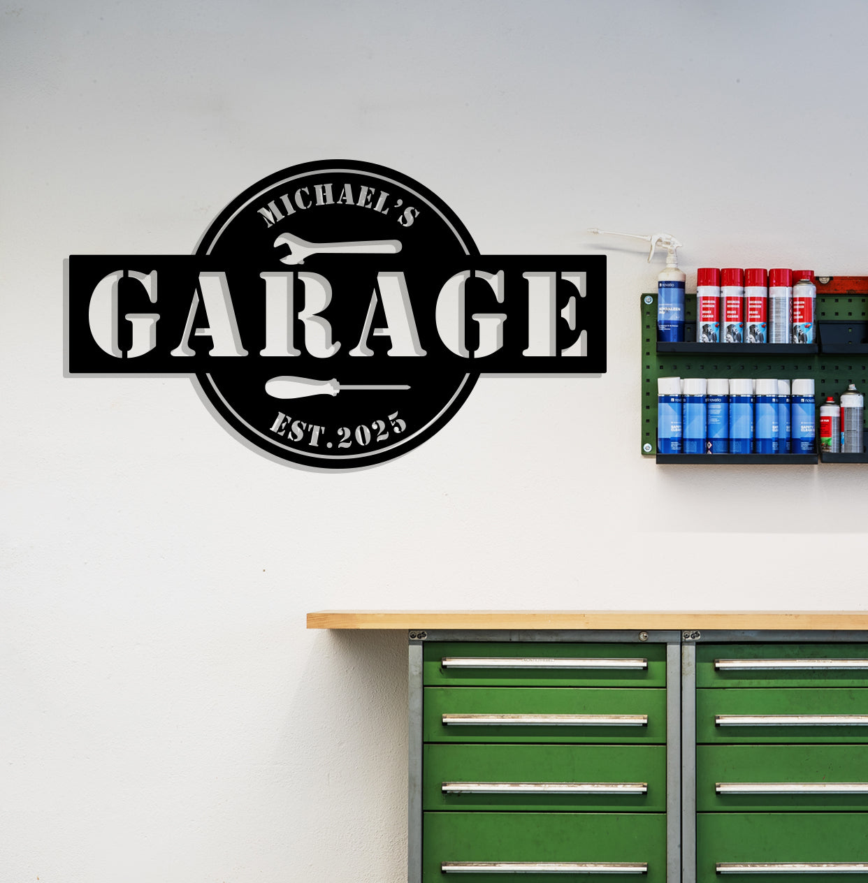 a garage sign on the wall above a green cabinet