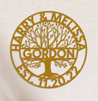 a golden metal sign with a tree on it