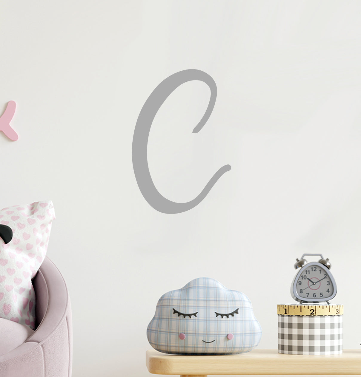 a child's room with a pink chair and a clock