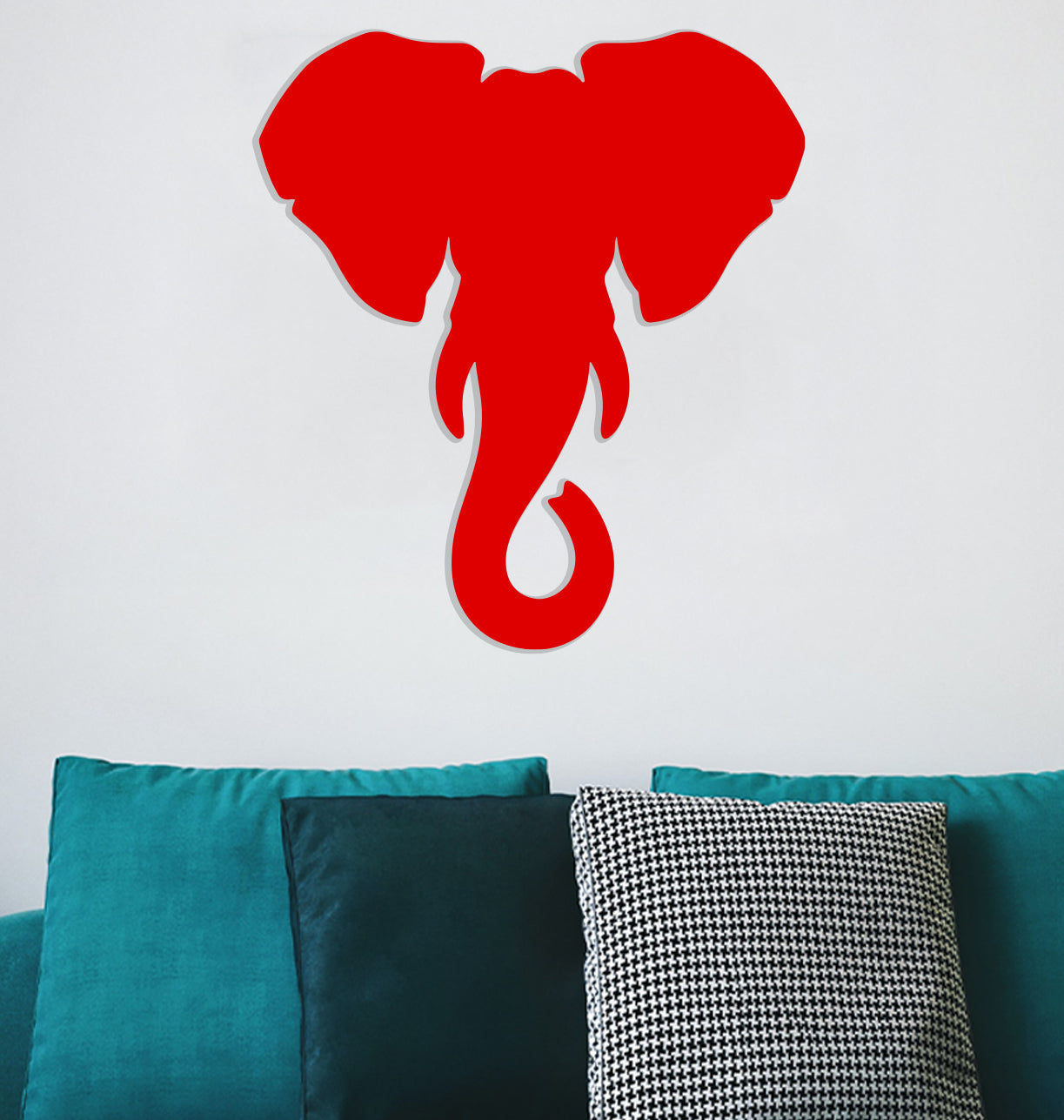 a red elephant cut out of paper on a wall